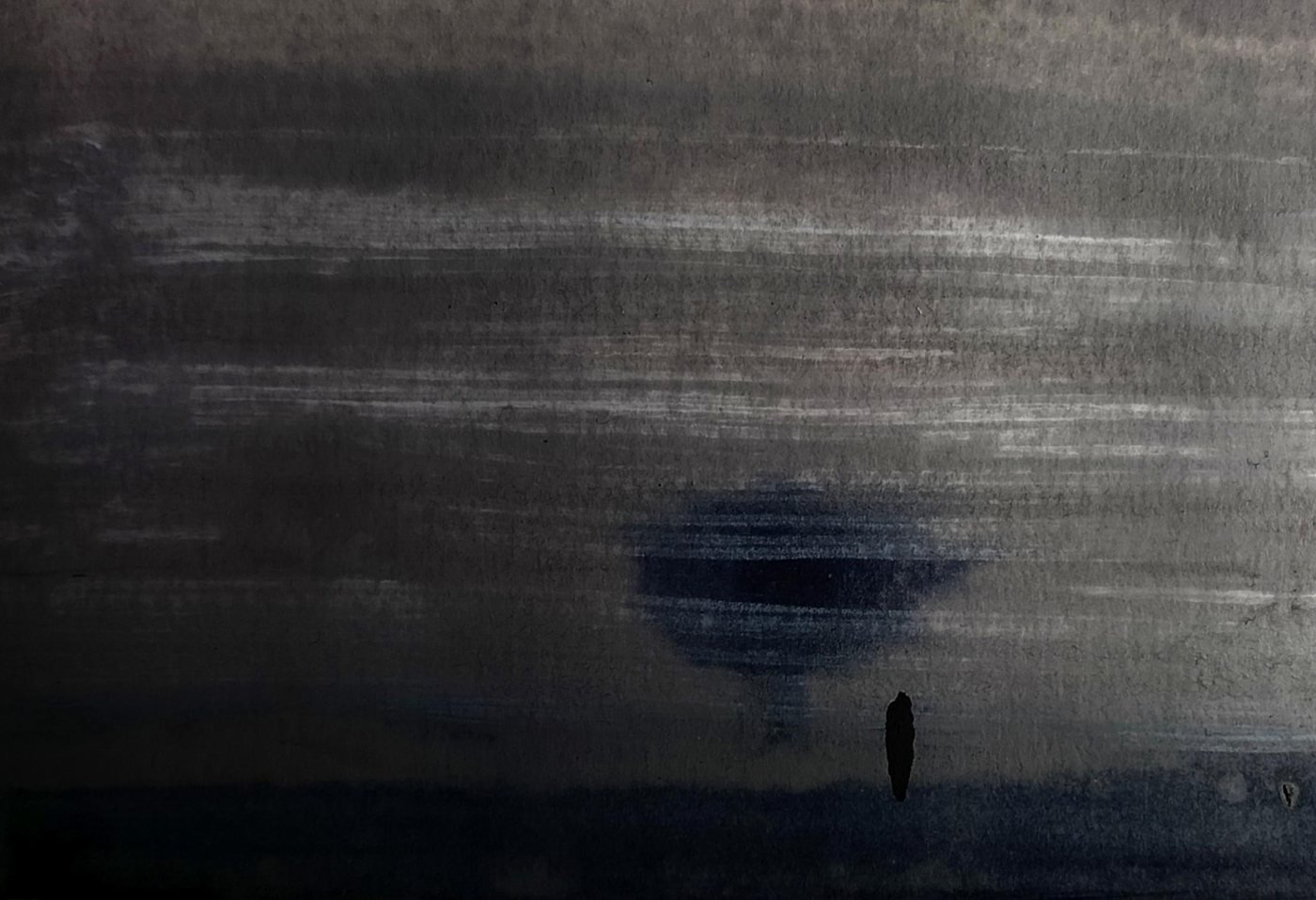 Dark grey inked sky with a smudged blue-black disc low on the horizon and a single small dark figure standing at the water's edge